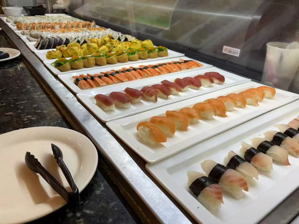Fresh sushi rolls arranged on serving trays